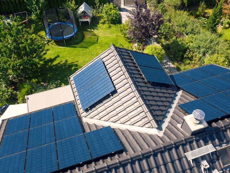 Haus mit Solarplatten von oben fotografiert, Blick in den Garten